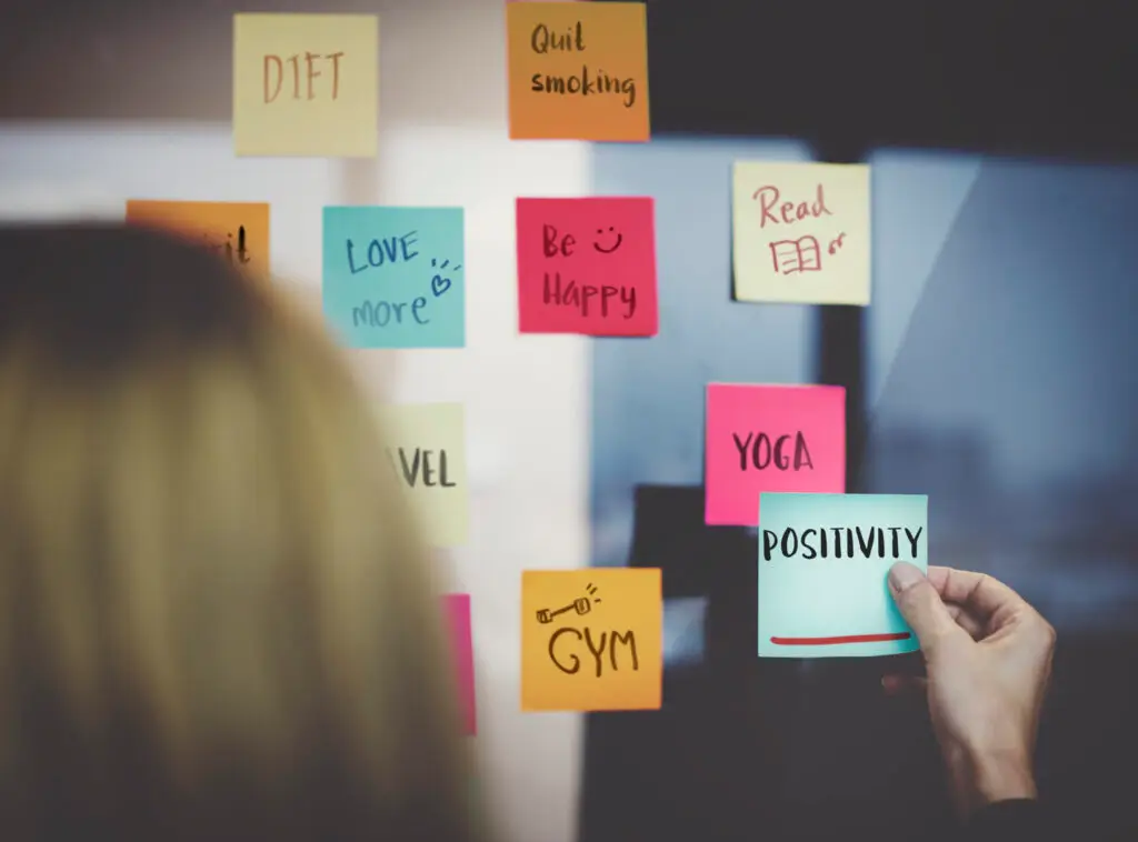 Young adult planning daily goals and personal habits for self-improvement and financial success in 2025 Personal Tips to Improve Life